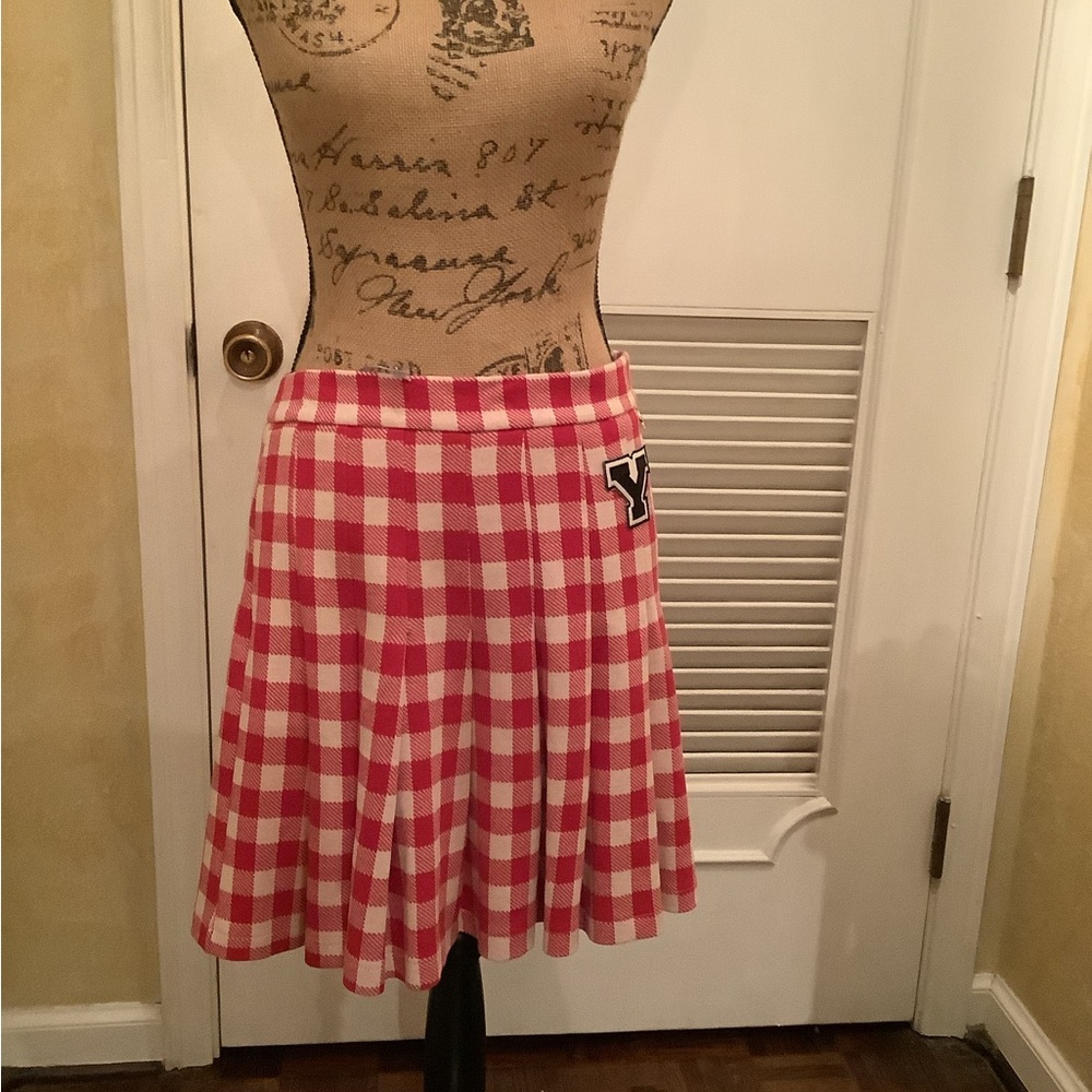 Collage style red and white pleated skirt with the letter Y